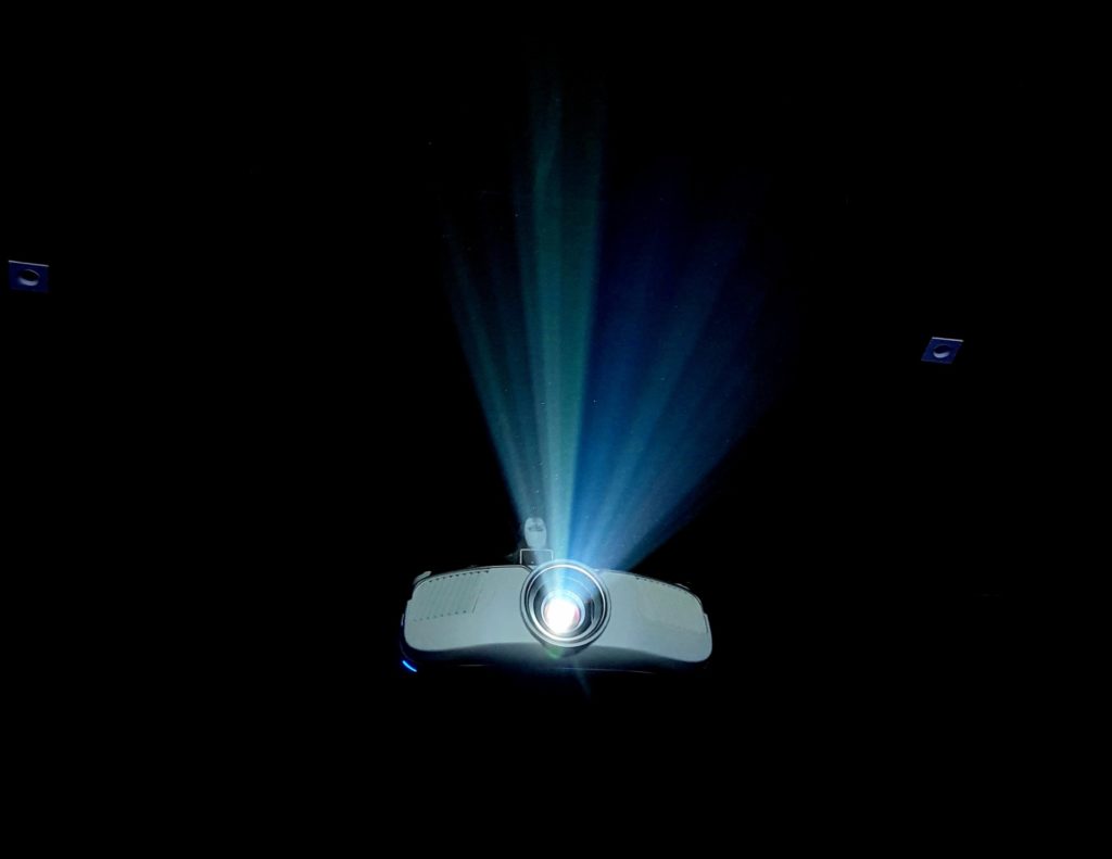 A projector lights up a dark room.